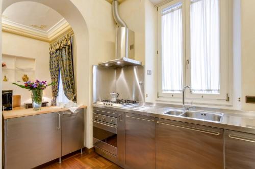 a kitchen with a stainless steel sink and a window at Vittoria Street Charming in Rome