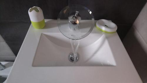 a white sink with a wine glass on top of it at Bella's House 4 com Piscina in Évora