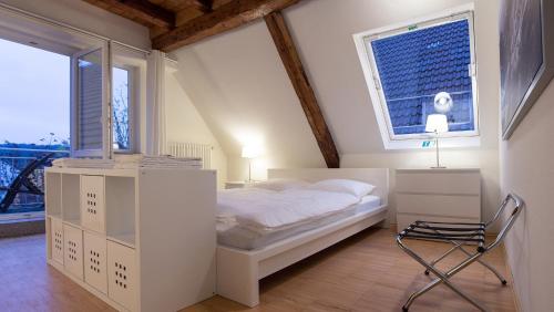 a bedroom with a bed and a chair in it at Hotel Krone Zentrum in Vaihingen an der Enz