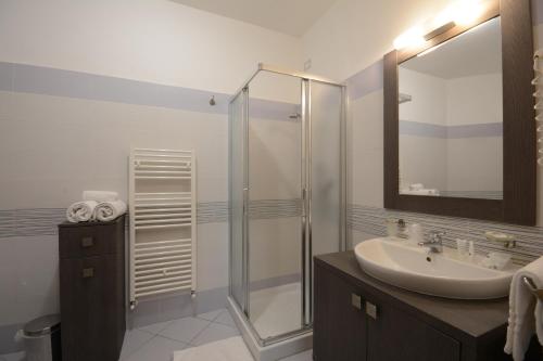 a bathroom with a glass shower and a sink at Kiara Residence in Giulianova