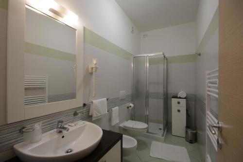 a bathroom with a sink and a toilet and a shower at Kiara Residence in Giulianova
