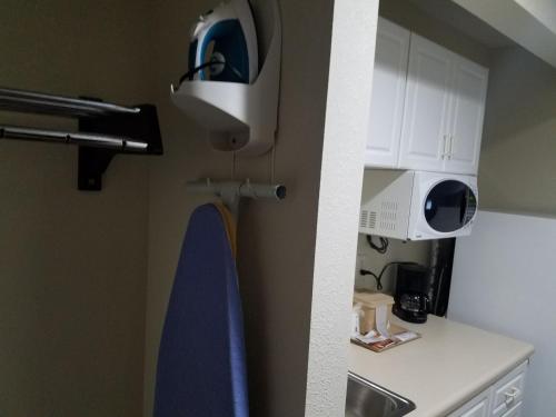 a kitchen with a sink and a microwave at Baymont by Wyndham Grovetown Augusta in Augusta