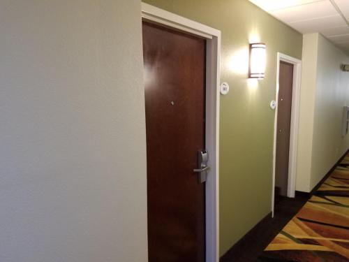 an open door in a hallway with a hallway at Baymont by Wyndham Grovetown Augusta in Augusta