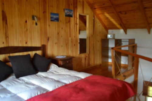 מיטה או מיטות בחדר ב-Cabañas Austral