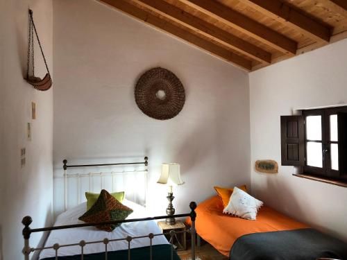 a bedroom with a bed and a lamp and a window at Quinta das Beldroegas-Turismo Rural in São Teotónio