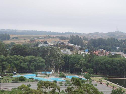 a group of swimming pools in a park at La Casa de Liber in Tandil