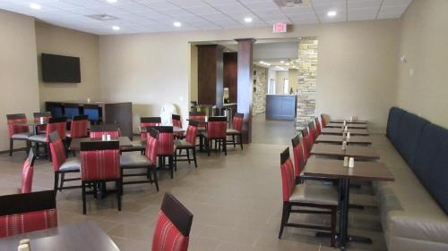 a dining room with tables and red chairs at MainStay Suites Coeur d'Alene in Coeur d'Alene