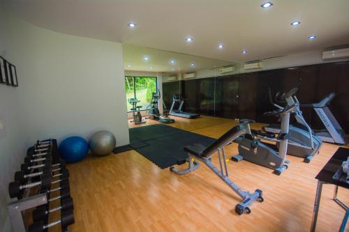 a gym with treadmills and exercise bikes in it at The Houben - Adult Only in Ko Lanta