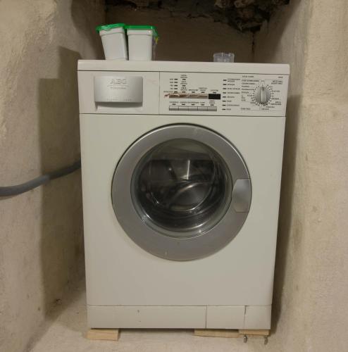 a white washing machine with two cups on top at full 4 floors house at the center in Antwerp