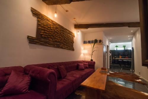 a living room with a red couch and a table at full 4 floors house at the center in Antwerp