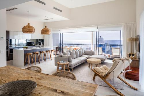 a living room with a couch and a table at First Light Mooloolaba, an Ascend Collection Hotel in Mooloolaba