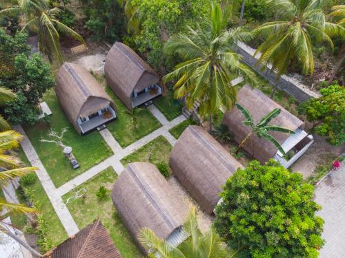an overhead view of a group of straw roofs at Bintang Bungalow in Nusa Penida