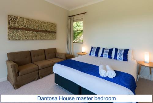 a bedroom with a bed and a couch at Dantosa Blue Mountains Retreat in Katoomba