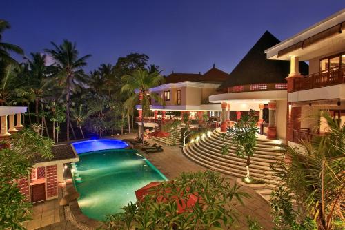a swimming pool in the middle of a house at Green Field Resort Ubud in Ubud