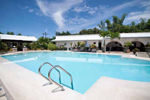 a large pool with blue water in a hotel at Panglao Regents Park Resort in Panglao