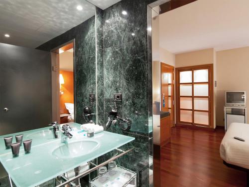 a bathroom with a sink and a shower at Hotel Ciutat Martorell in Martorell