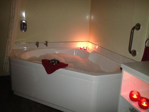 a bath tub with a person in it with lights in it at Lakefront Lodge in Te Anau