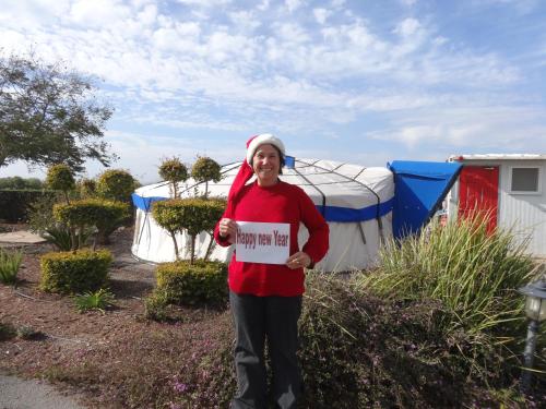 a woman holding a sign in front of a tent at Sea of Galilee - Genghis Khan in The Golan in Giv'at Yo'av