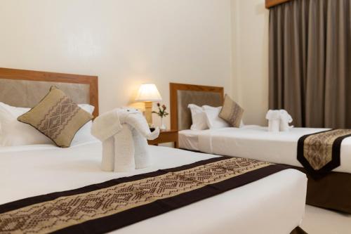 a hotel room with two beds with an elephant on them at Bagan Sense Hotel in Bagan