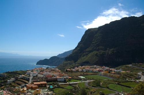 a town on a mountain next to the ocean at Casa Rural Los Helechos in Agulo