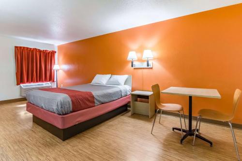 a small hotel room with a bed and a table at Motel 6-Raleigh, NC - Cary in Cary