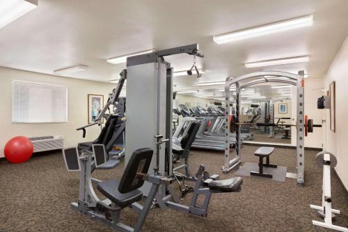 a gym with treadmills and machines in a room at Baymont by Wyndham Hearne in Hearne