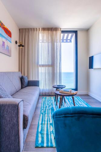 a living room with a couch and a table at Roxon Sea Sand Bat Yam in Bat Yam
