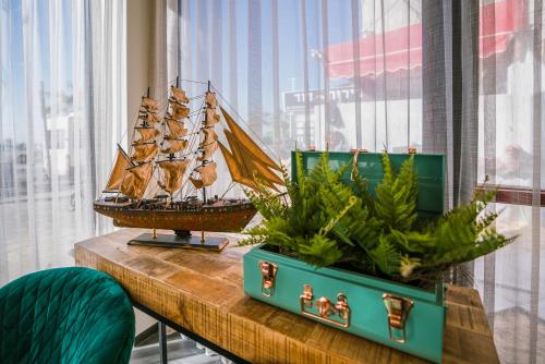 a model of a ship on a table with plants at Roxon Sea Sand Bat Yam in Bat Yam