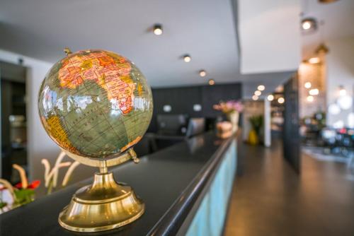 a globe on top of a counter in a store at Roxon Sea Sand Bat Yam in Bat Yam