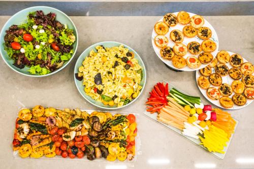 a table topped with bowls of different types of food at Roxon Sea Sand Bat Yam in Bat Yam