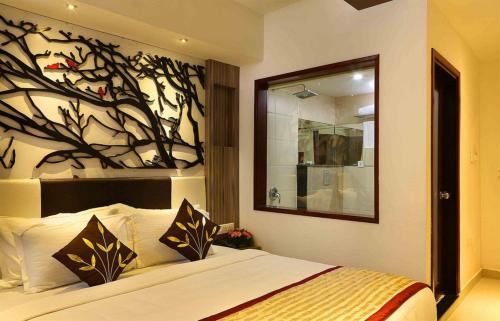a bedroom with a bed with a painting on the wall at Red sparrow in Munnar