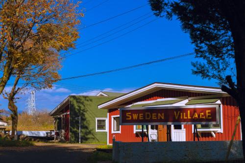 a red building with a sign that reads silver village at Nikko Sweden Village in Imaichi