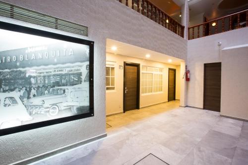 a building with a picture of a car on the wall at Hotel Diligencias in Mexico City