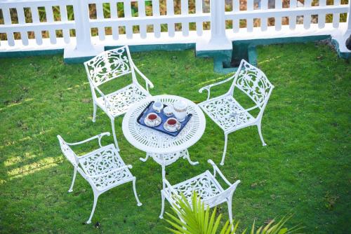 a group of white chairs and a table with food on it at Hotel Mount Castle in Hatton