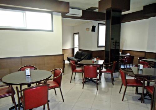 a dining room with tables and chairs in a restaurant at Hotel Altiana in Ourense