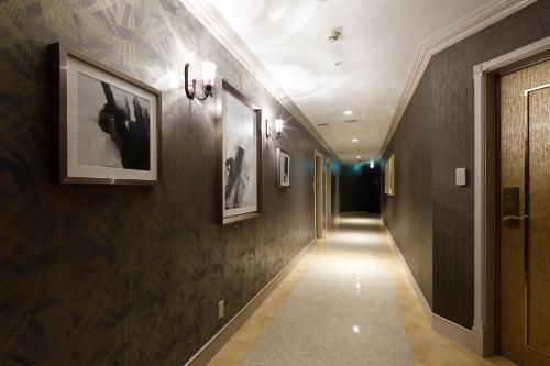 a hallway with dark brown walls and a long corridor at Hotel ValentineTogo (Adult Only) in Togo