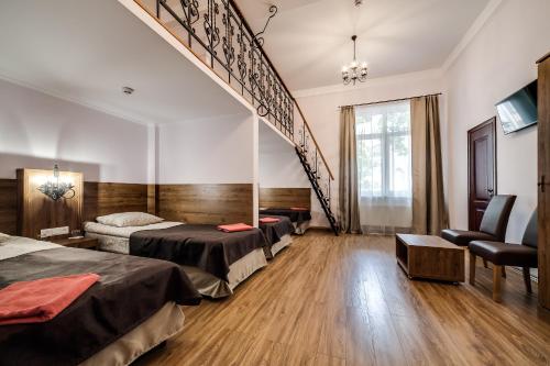 a hotel room with two beds and a staircase at Kryva Lypa in Lviv