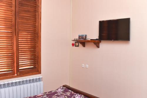 a flat screen tv on a wall in a room at Sofia in Kutaisi