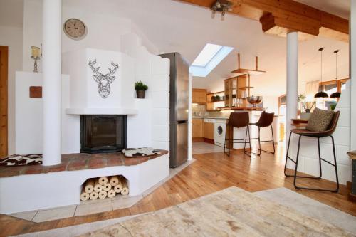 a kitchen and living room with a fireplace at BELLE KITZ im Zentrum by Belle Stay in Kitzbühel