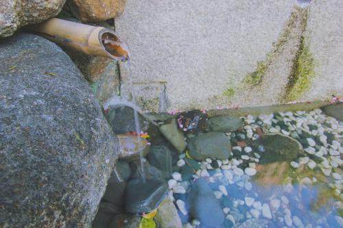 a pipe sitting on top of a pile of rocks at I Osaka Traditional in Osaka