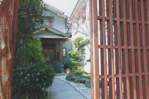 an entrance to a house with a red fence at I Osaka Traditional in Osaka