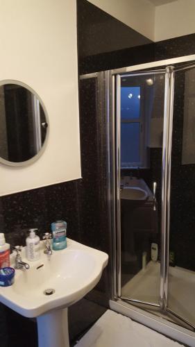 a bathroom with a shower and a sink and a shower at SPRINGBANK Holiday Home in Inverness
