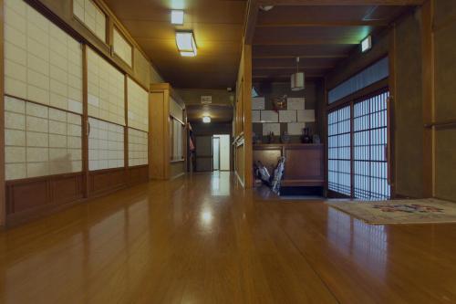 an empty room with a hard wood floor and windows at I Osaka Traditional in Osaka