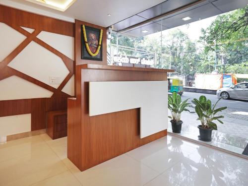 a reception area of a building with a large white sign at Treebo Trend Akshaya Bull Temple in Bangalore