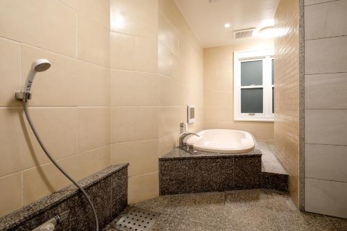 a bathroom with a shower and a toilet in it at Hotel ValentineTogo (Adult Only) in Togo