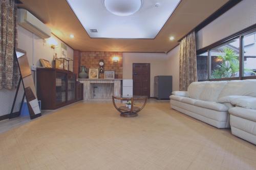 a living room with a couch and a fireplace at I Osaka Traditional in Osaka