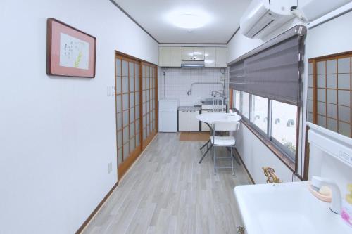 a small room with a table and a sink at I Osaka Traditional in Osaka