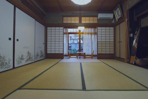 an empty room with a room with a table and a door at I Osaka Traditional in Osaka