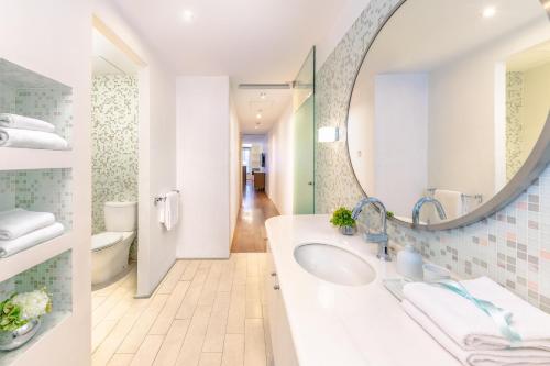 uma casa de banho com um lavatório e um espelho em The Connaught em Hong Kong