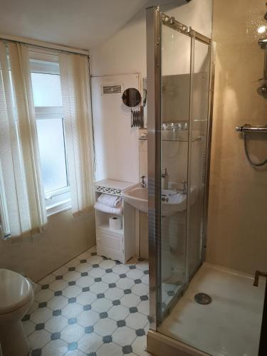 a bathroom with a shower and a sink at East Mount House in Barrow in Furness
